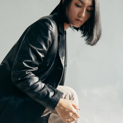 Leather jacket and tan pants