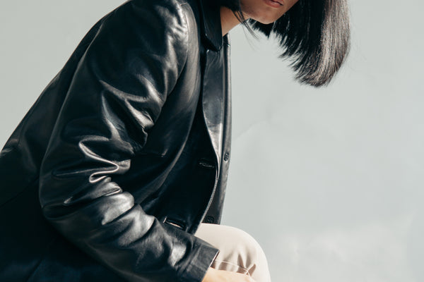 Leather jacket and tan pants